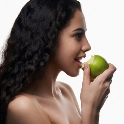 Woman biting green apple