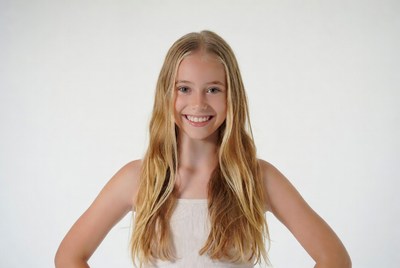 Blonde girl smiling with arms crossed