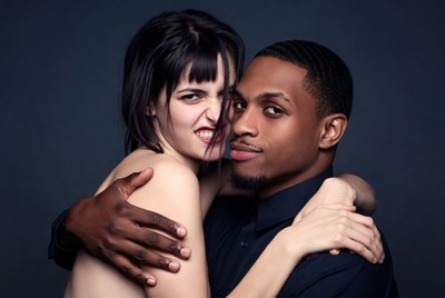 Black man embracing topless woman
