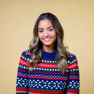 Smiling woman in colorful Christmas sweater
