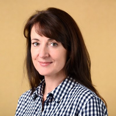 Smiling woman in checkered shirt