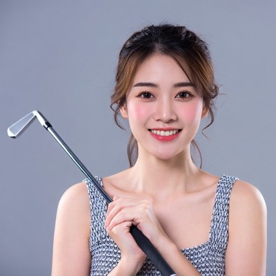 Asian woman holding golf club