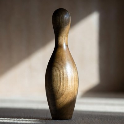 Wooden bowling pin in sunlight