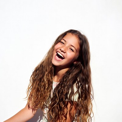 Teen girl laughing with curly hair