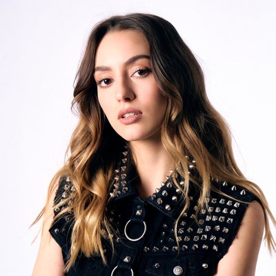 Woman in studded black vest