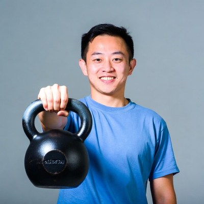 Asian man holding kettlebell