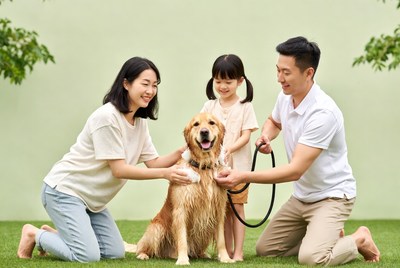 Asian family bathing golden retriever
