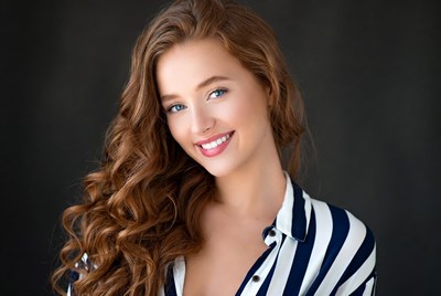 Smiling woman with wavy red hair