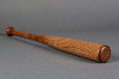 Wooden baseball bat on gray background