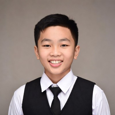 Asian boy smiling in vest suit
