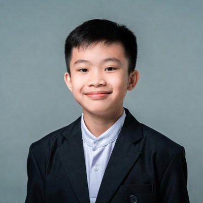Asian boy in black suit smiling