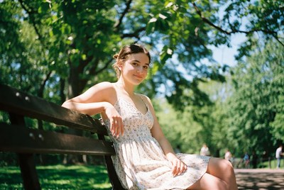Young woman sitting on park bench