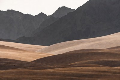 Layered Sand Dunes and Mountains