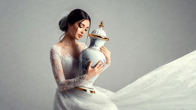Bride holding ornate porcelain vase
