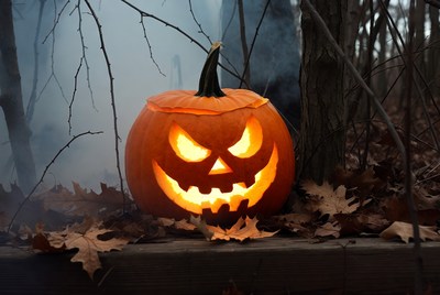Jack-o'-lantern in foggy forest