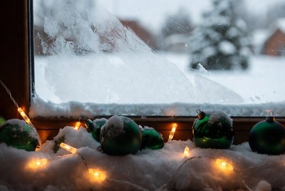 Green Christmas Ornaments on Snowy Window