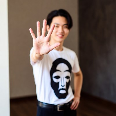 Asian man showing stop hand gesture