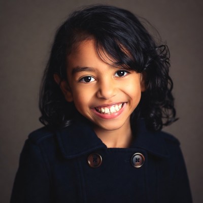 Smiling mixed-race girl in navy coat