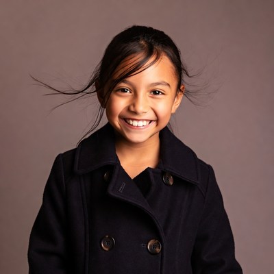 Smiling girl in black coat