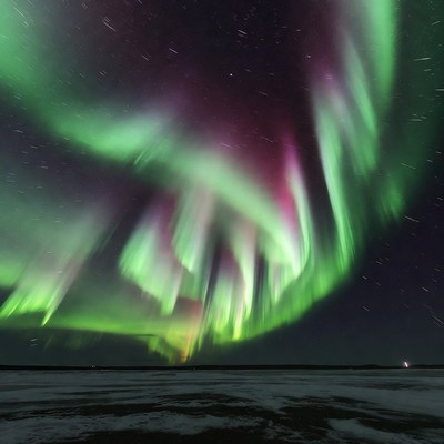 Vibrant Northern Lights over Snowy Landscape