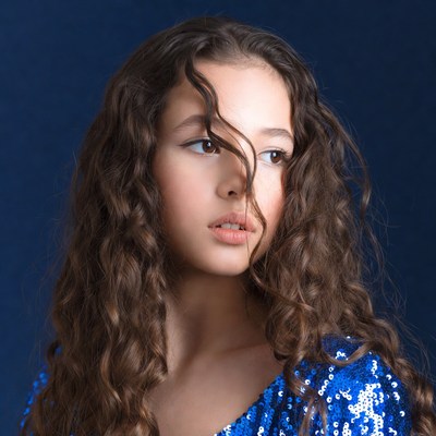 Girl with curly hair in sequin dress