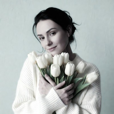 Woman holding white tulips