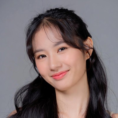 Asian woman smiling with bangs