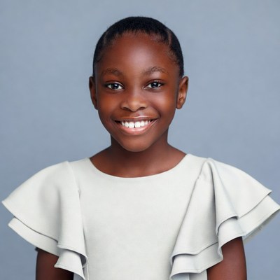 Smiling African-American girl in white blouse