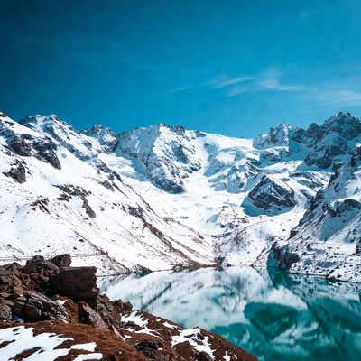Snowy Mountains Reflecting in Turquoise Lake