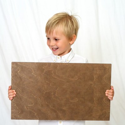 Blond boy holding blank sign