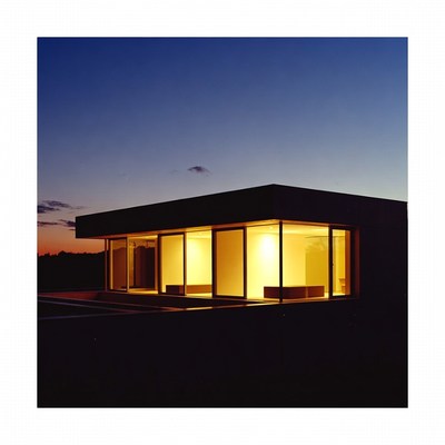 Modern House at Night with Lit Windows