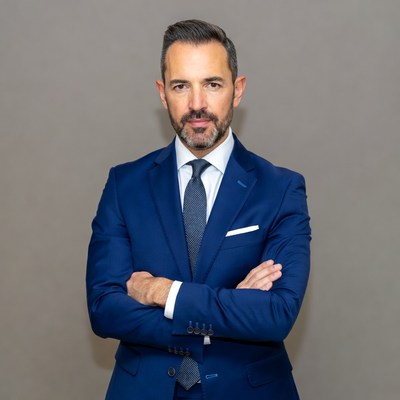 Man in blue suit with arms crossed