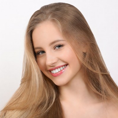 Smiling young woman with long blonde hair
