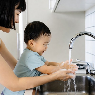 Asian mother and toddler washing hands