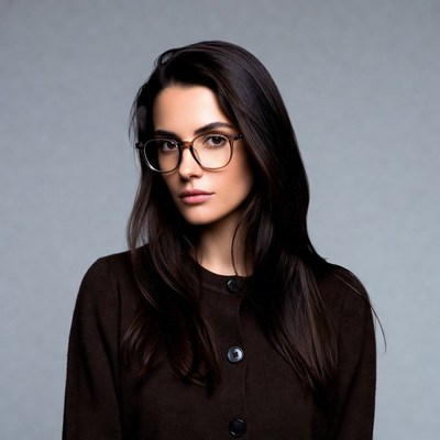 Woman with glasses in brown cardigan