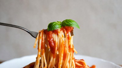 Spaghetti with tomato sauce on fork