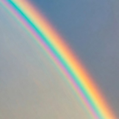 Vibrant Rainbow in Blue Sky