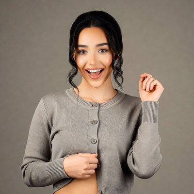Smiling woman opening gray cardigan