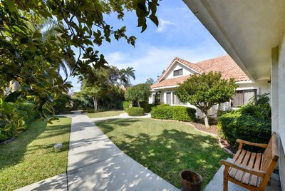 Suburban House with Palm Trees and Walkway