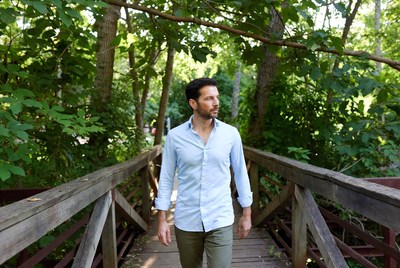 Man walking on wooden bridge in forest