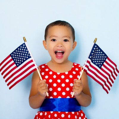 Asian girl holding American flags