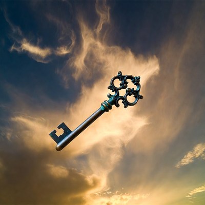 Vintage key floating in clouds