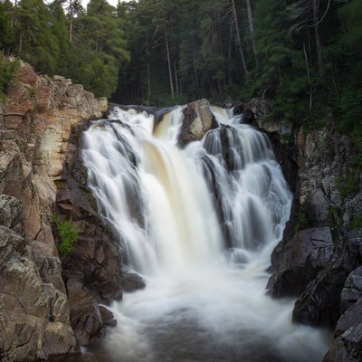 Waterfall cascading over rocks in forest