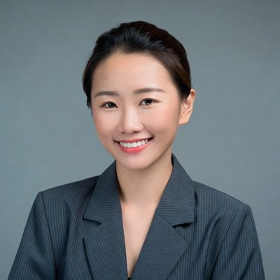 Asian woman in gray suit smiling
