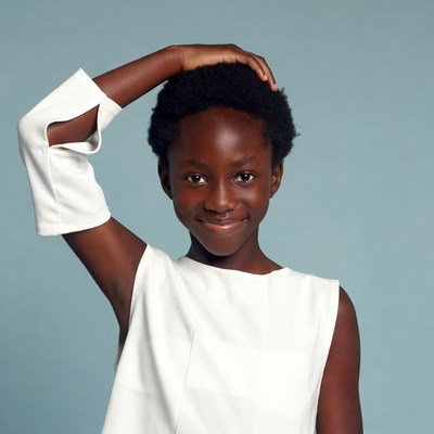 Smiling African girl hand on head