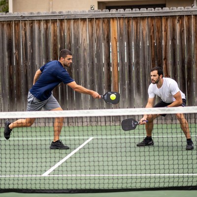 Two men playing pickleball