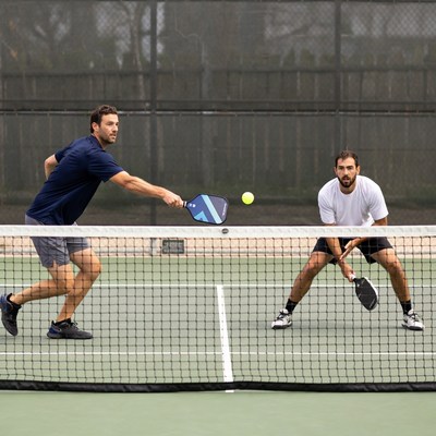 Two men playing pickleball match