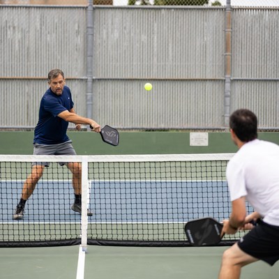 Two men playing pickleball match