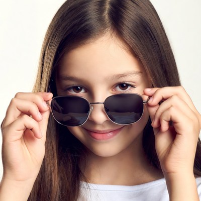 Girl holding sunglasses smiling