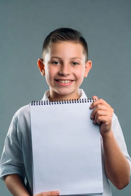 Boy holding blank notebook